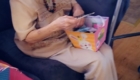 senior woman opening a gift